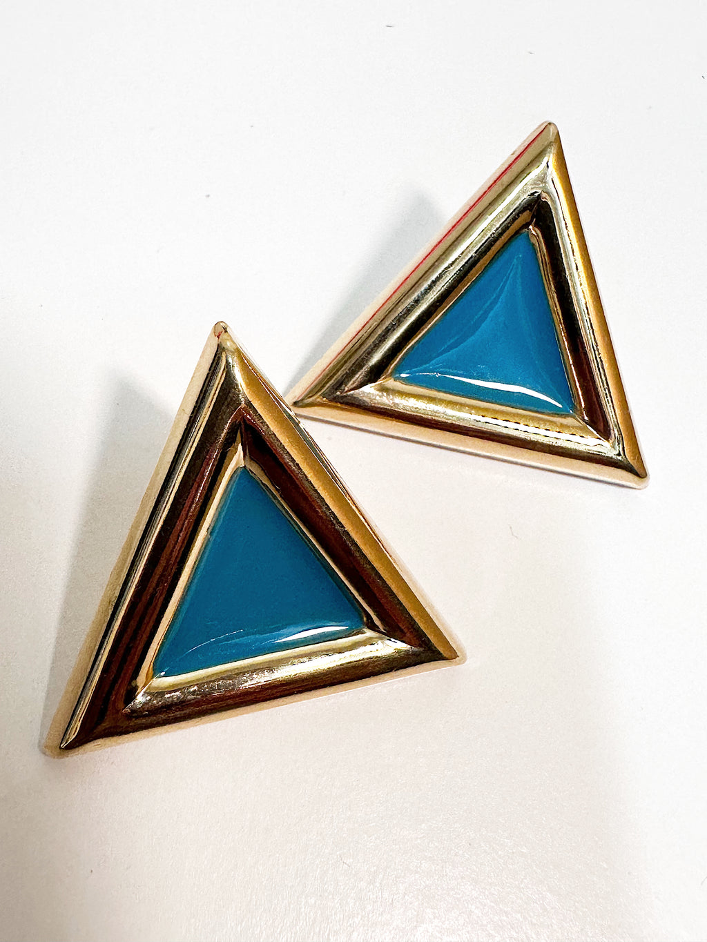 Turquoise enamel gold tone triangular stud earrings for pierced ears.