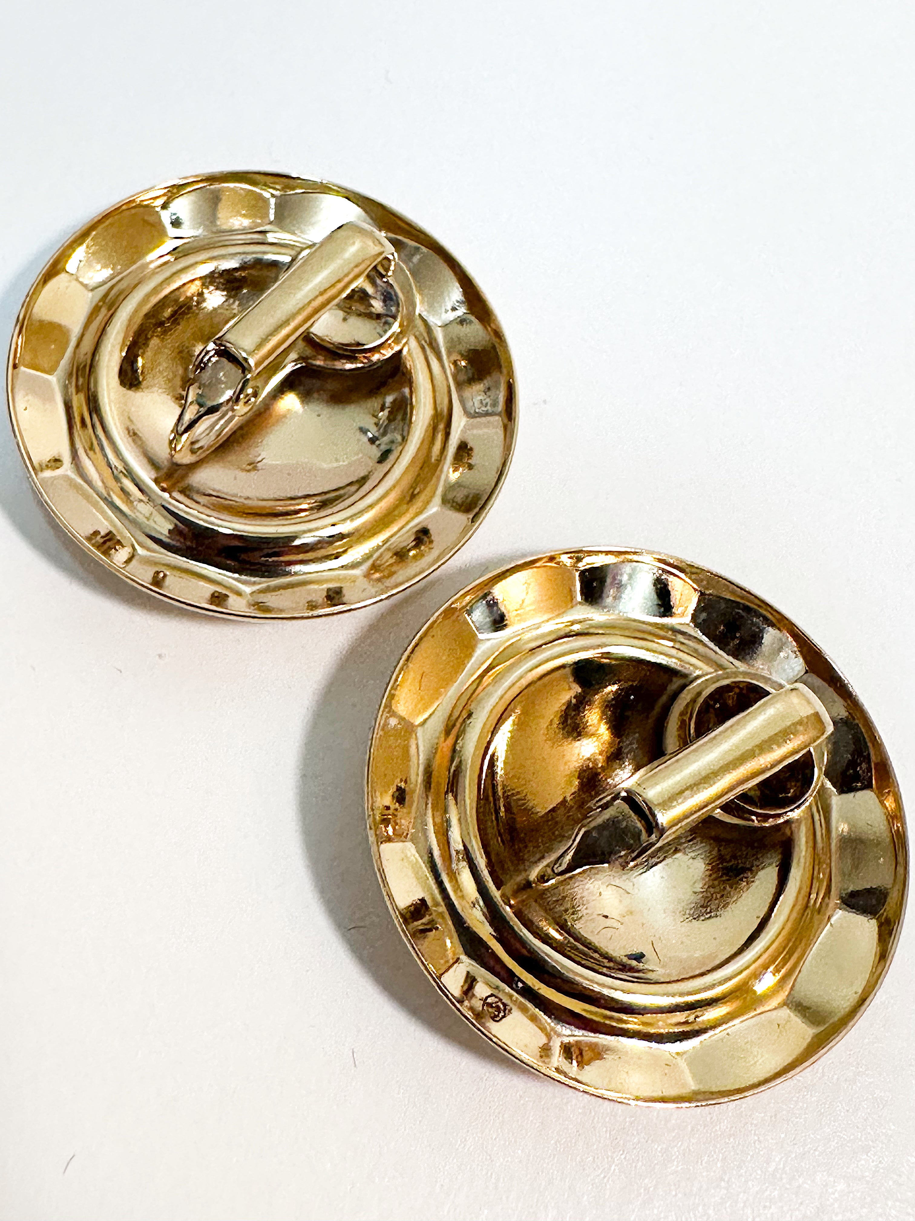 Gold dome clip on earrings.