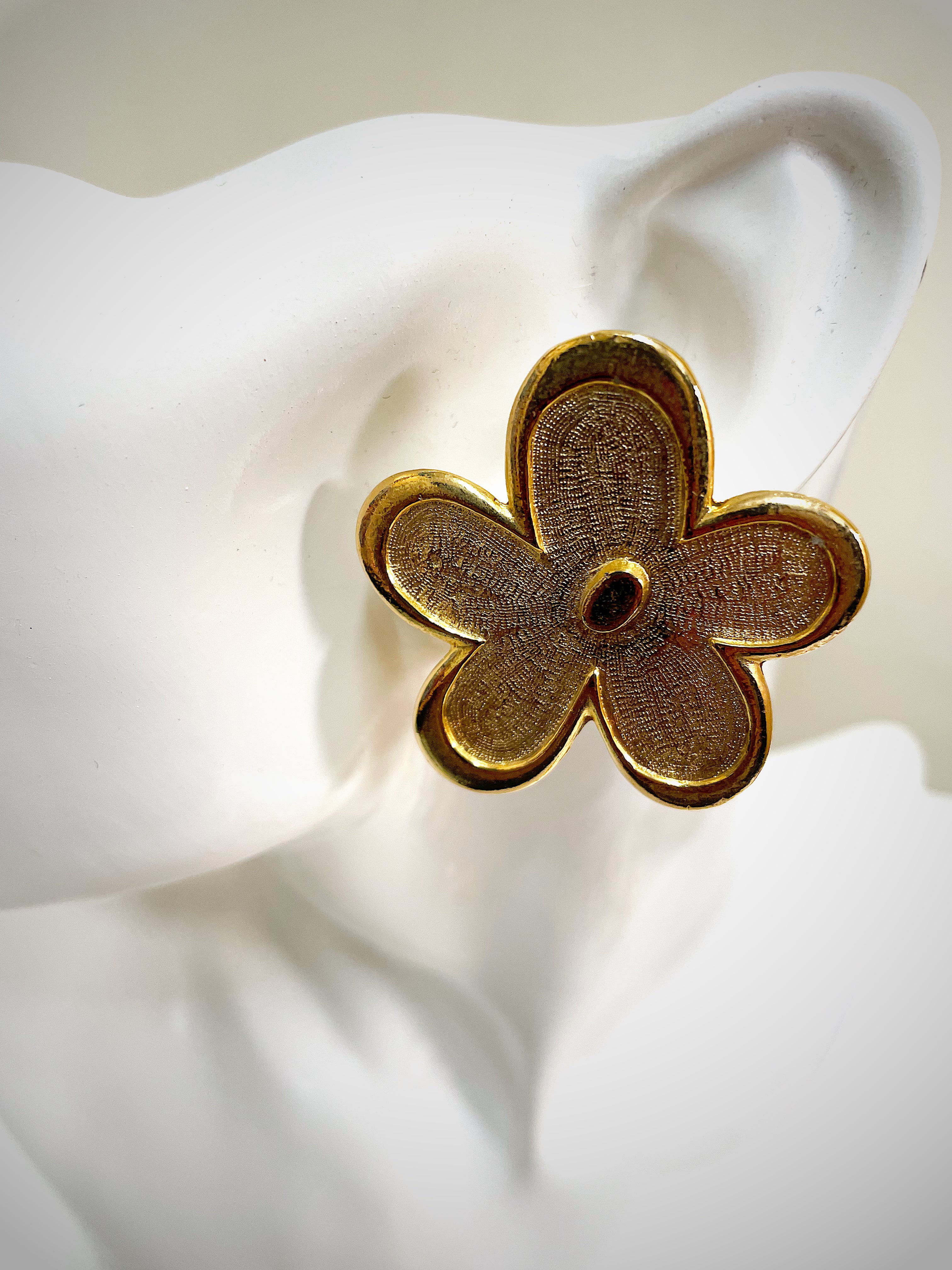 Oversized floral gold plated clip on statement earrings.