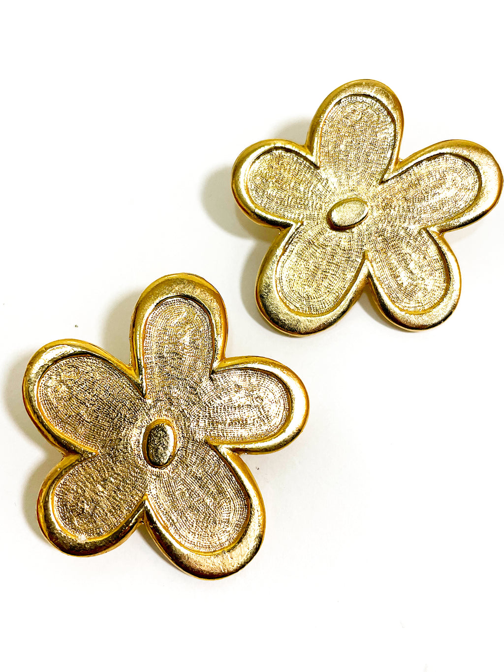 Oversized floral gold plated clip on statement earrings.