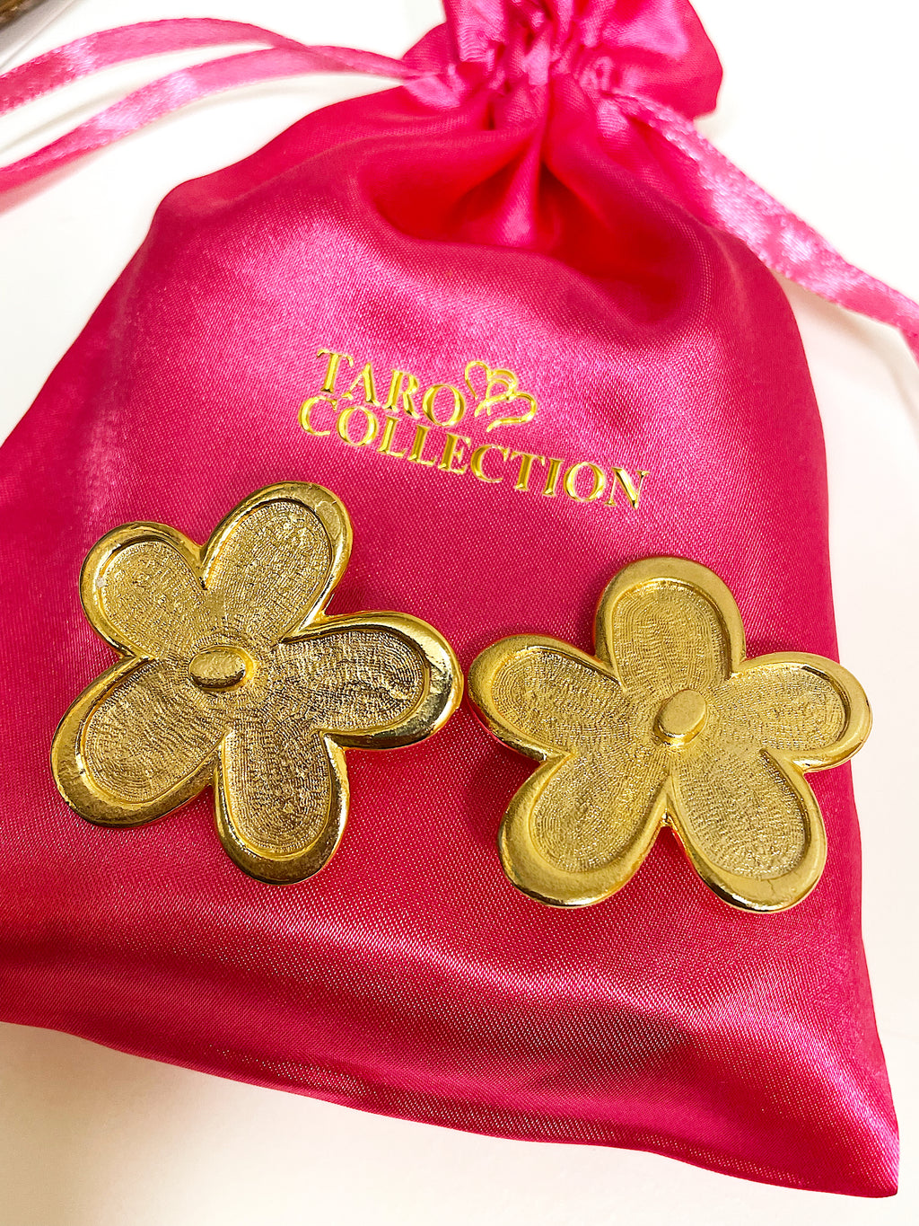 Oversized floral gold plated clip on statement earrings.