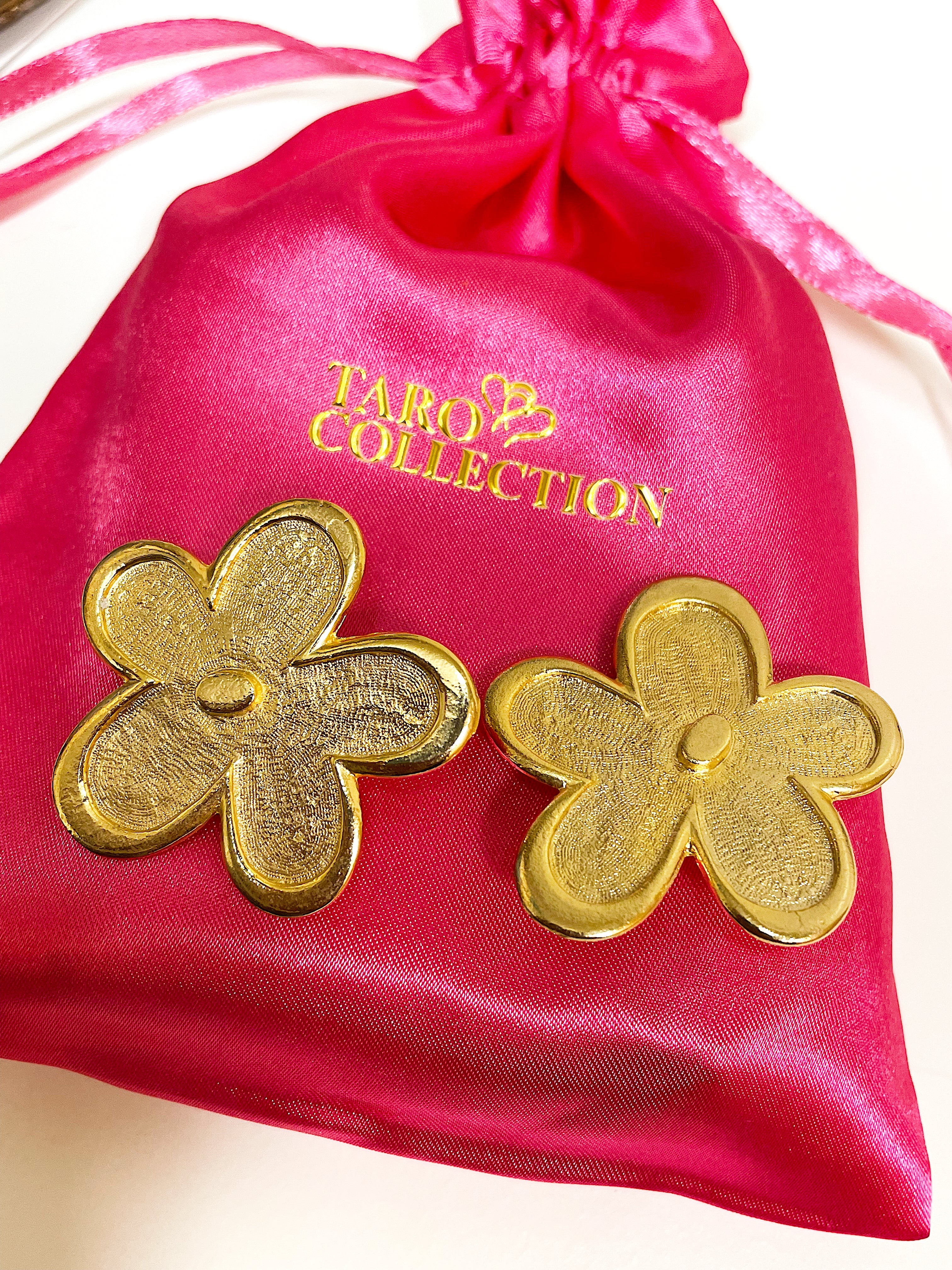 Oversized floral gold plated clip on statement earrings.