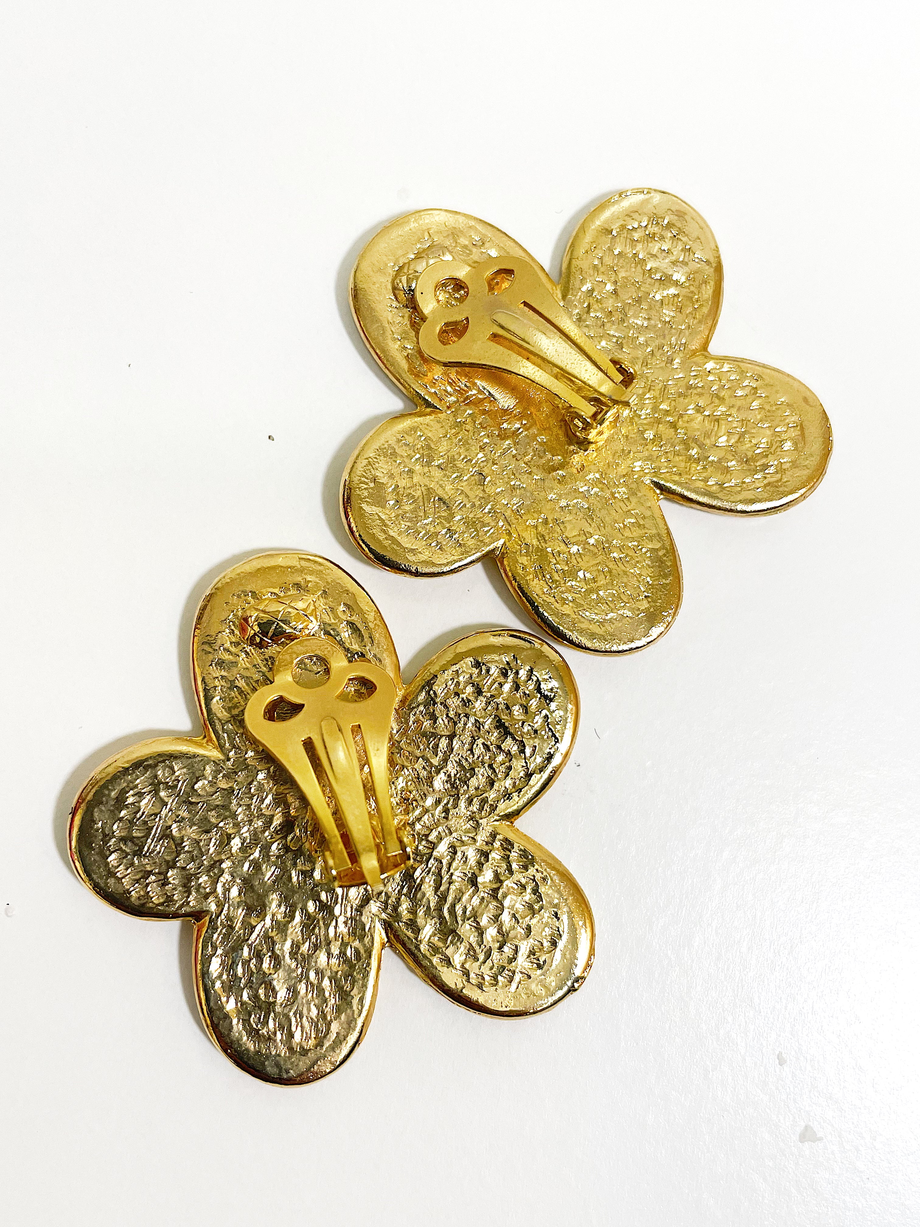 Oversized floral gold plated clip on statement earrings.