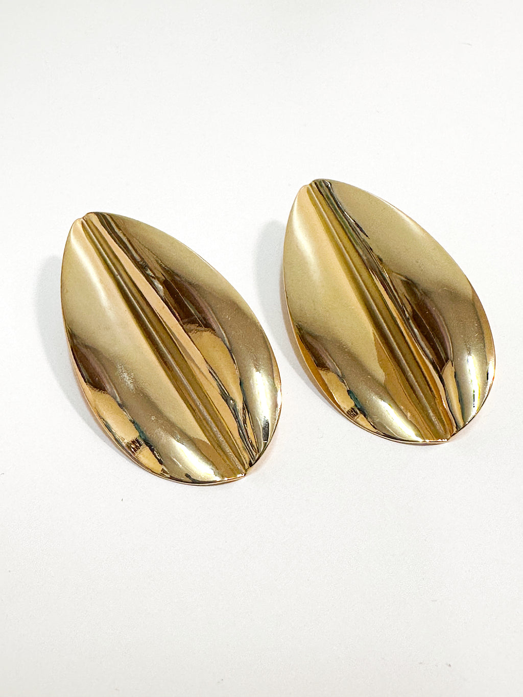 Oversized gold plated over brass leaf statement earrings for pierced ears.