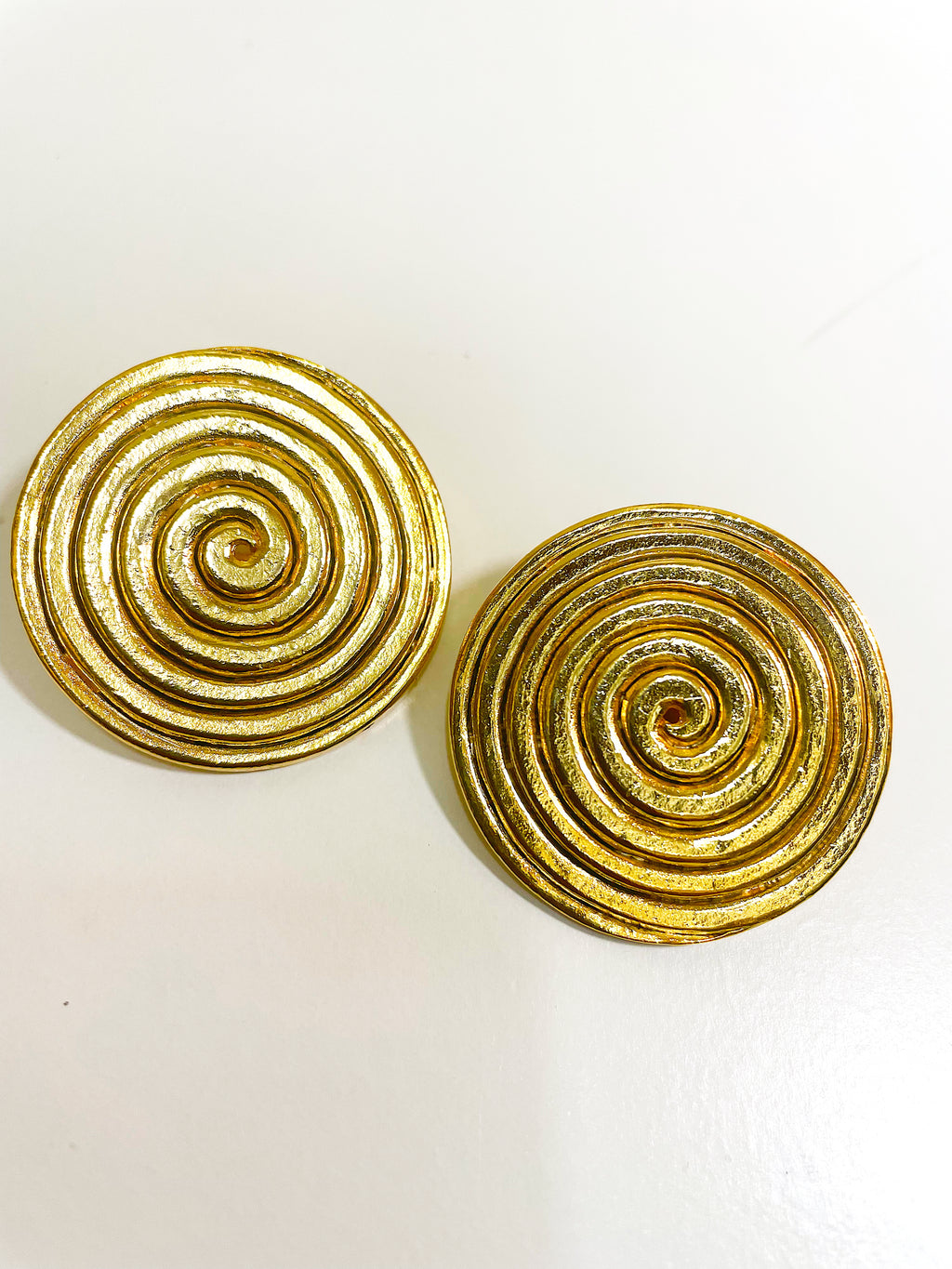 Large gold plated round swirl disc button clip on earrings.