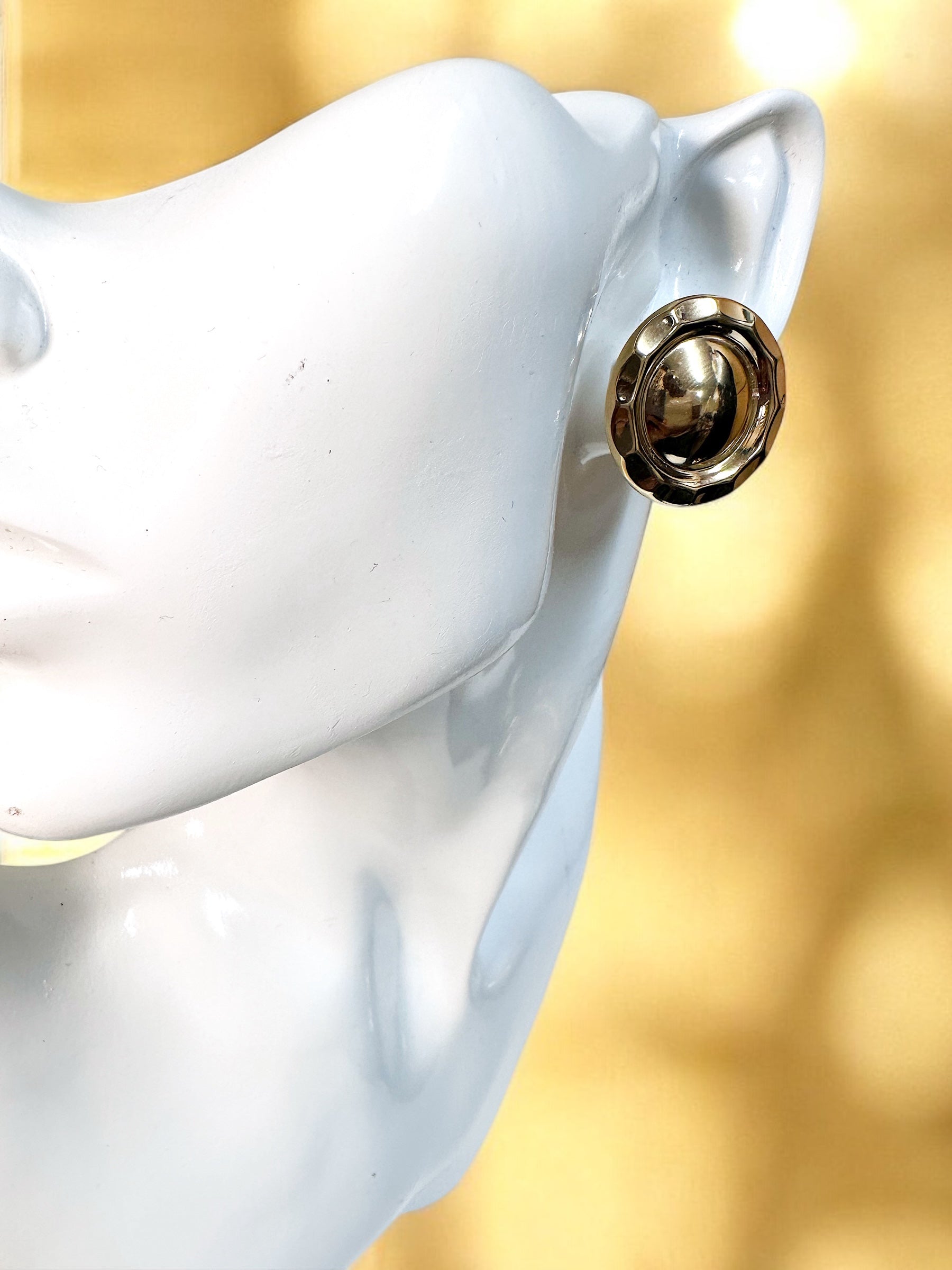 Gold dome clip on earrings.