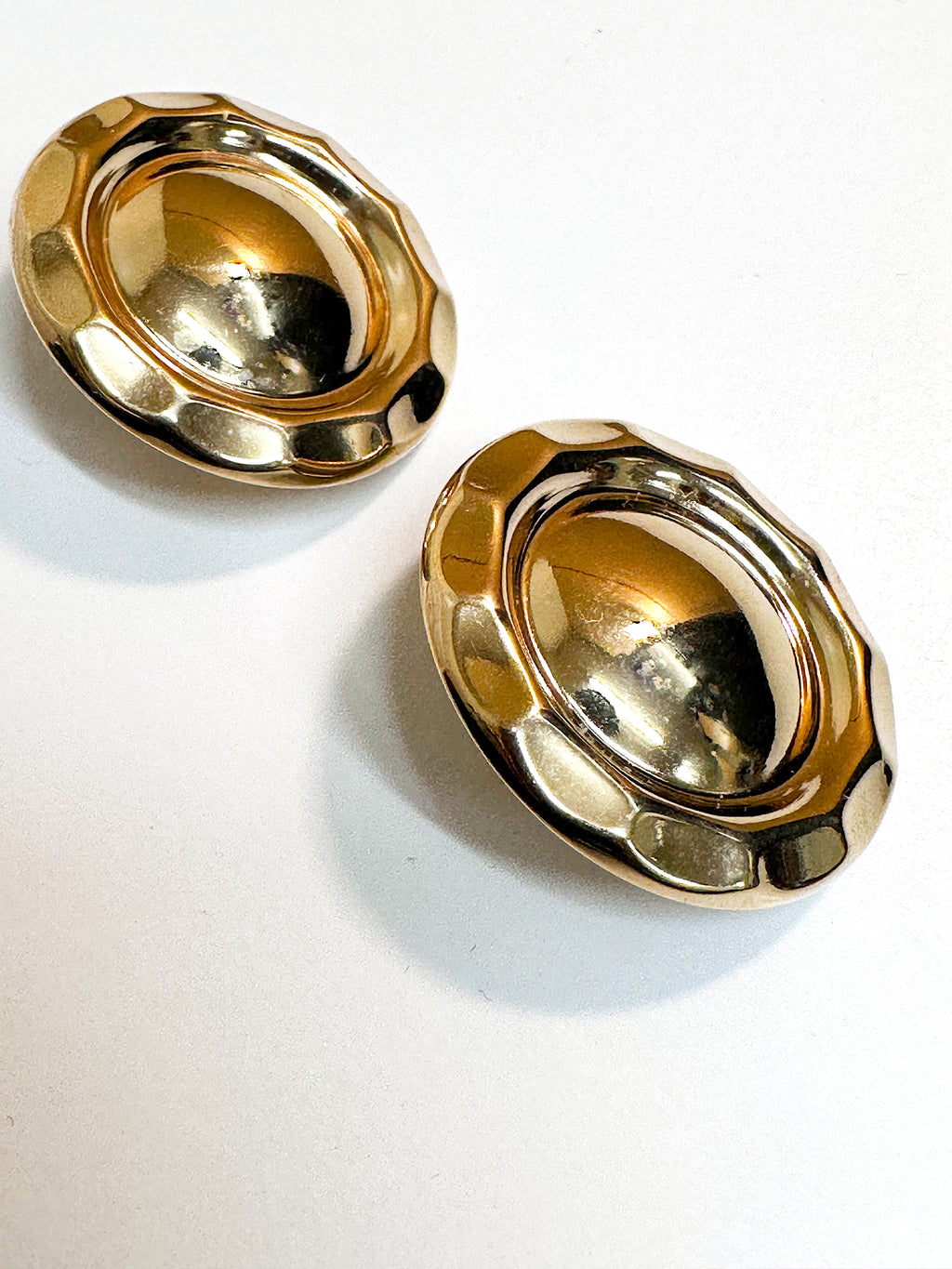 Gold dome clip on earrings.